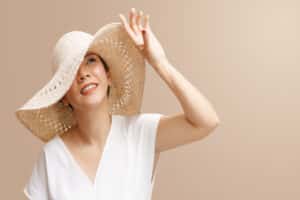 A woman wearing a large hat to prevent sun damage in Dallas
